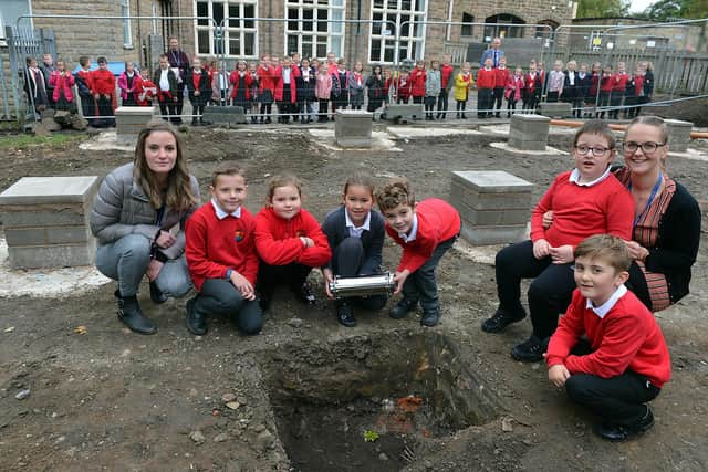 Highfield Hall Primary School pupils Harry, Susie, Elliott, Lily, Alex and Tommi-Lee with teachers Miss Sullivan and Mrs Webster during the planting of the time capsule. Pictures by Brian Eyre.