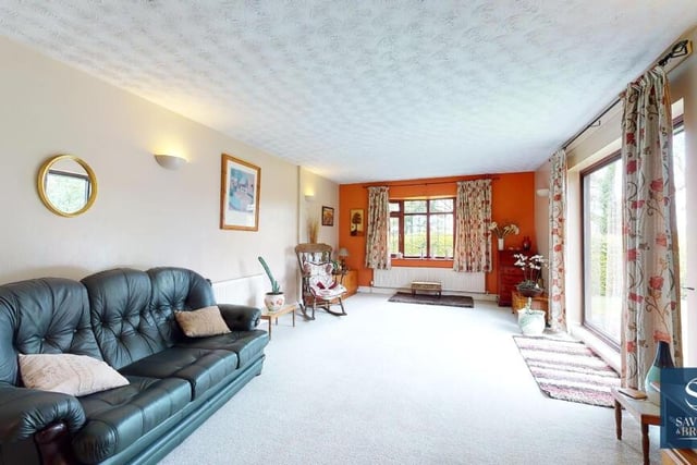 Next to the lounge is this large sitting room or family room. The bay window offers delightful, far-reaching views of the garden and open fields that adjoin the bungalow.