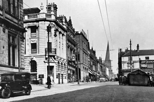 Chesterfield High Street, in 1925, looking towards the Crooked Spire. The ornate building on the corner is now home to HSBC