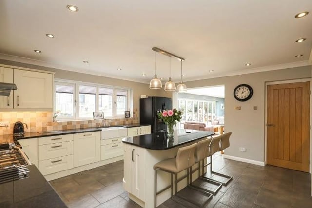 The kitchen is kitted out with fitted wall and base units,, integrated appliances and granite worktops with inset Belfast sink. An island enables relaxed dining at breakfast time.