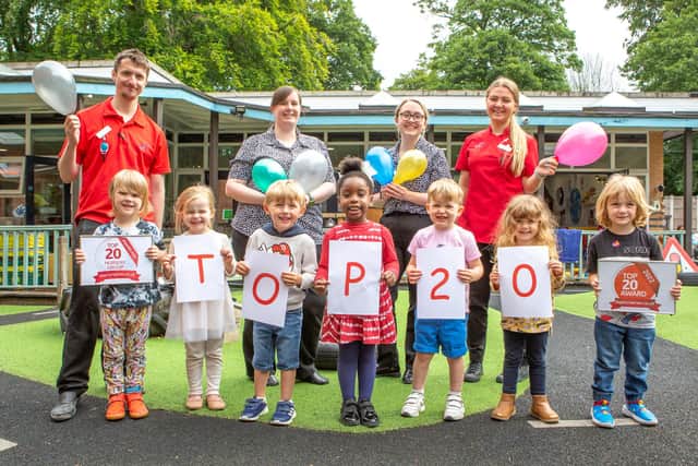 Staff and children at Children 1st @ St Peter & St Paul celebrate being amongst the 'Most Recommended' nurseries by parents
