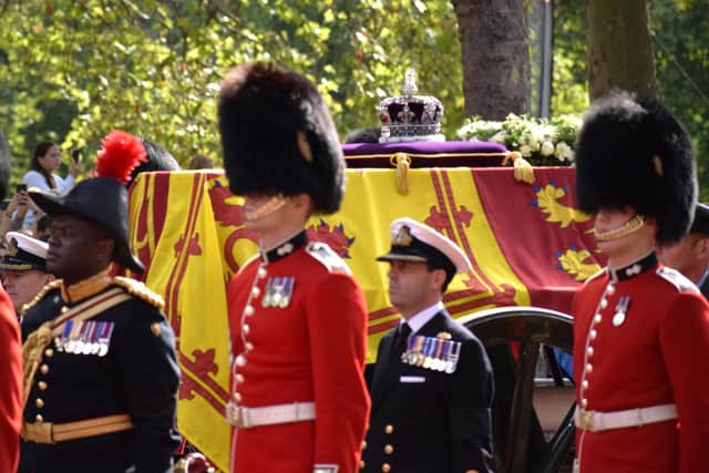 The Queen’s coffin was draped in the royal standard. On top, the Imperial State Crown had been joined by the orb and the sceptre.