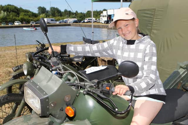 Jasmine Vaughan on one of the military motorcycles on display.