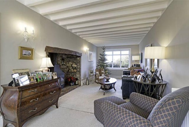 There are three separate living spaces on the ground floor, with one of these boasting an original fireplace and wood burning stove.