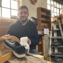 Darren Cox lost his job as a chef when the pub he worked at shut in the Covid lockdown. Pictured with the trainers he wore when homeless and the bread bin he restored at Growing Lives.