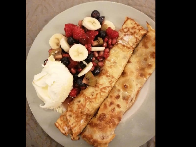 Chocolate and salted caramel filling covered in maple syrup, with raspberries, pomegranate, kiwi, blueberries and banana in raspberry compote with clotted cream. Wow!