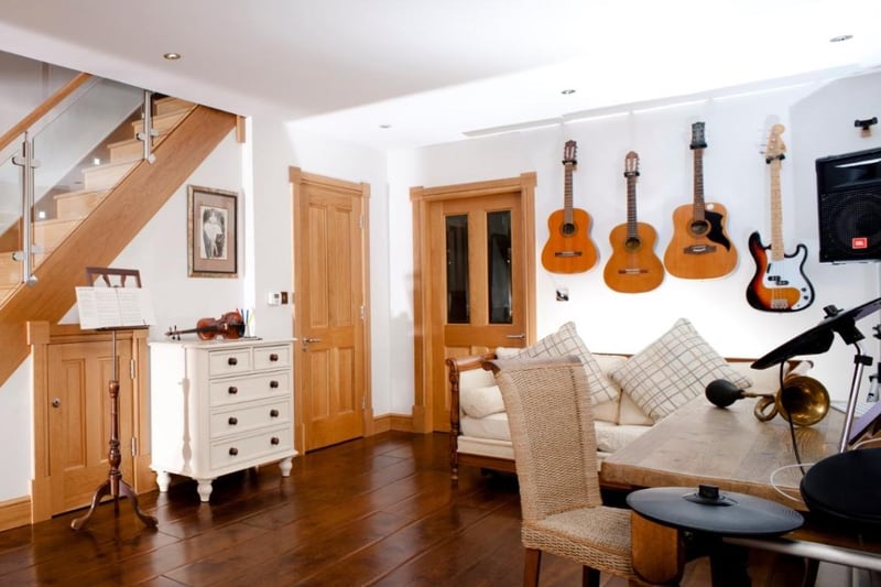 Stairs lead up to the music room which includes stunning rural views, WC and access to bedroom five.