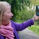 Coun Carolyn Renwick, cabinet member for economic growth at NE Derbyshire District Council, uses the new phone app to spot  a dinosaur in Ince Piece wood, Eckington.
