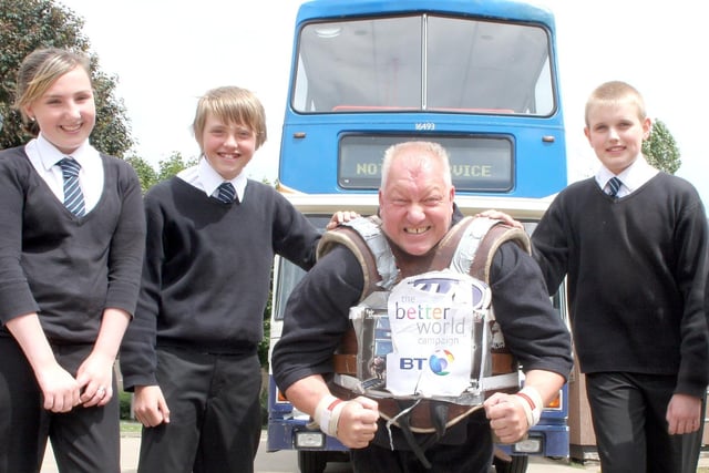 Bolsover School pupils Marissa Andrew, Dominic Christopher and Jake Smart with 'Big Dave' who pulled a bus and talked to year 7 students about bullying in 2008.