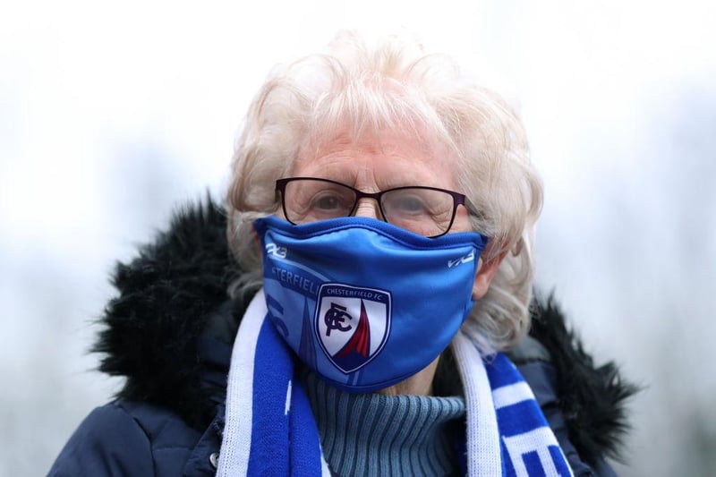 A fan of Chesterfield is seen wearing a face mask as they wait outside the stadium prior to the Vanarama National League match between Chesterfield and FC Halifax Town at Technique Stadium on December 28, 2021.