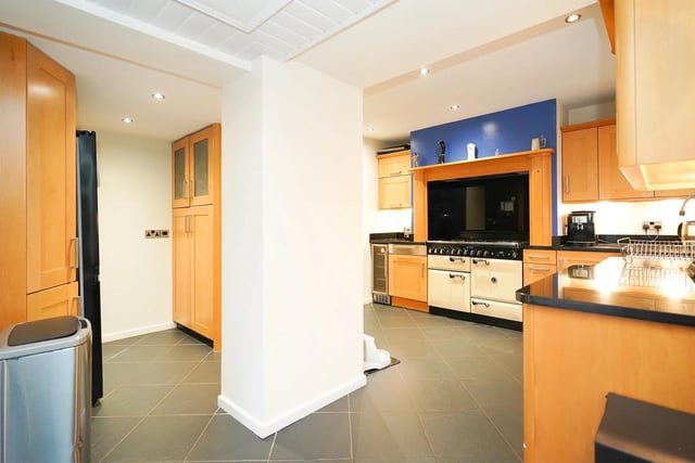 The well-presented kitchen contains bespoke fitted cabinets and a Rangemaster stove.
