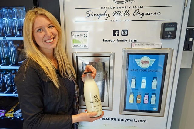 Charlotte Kirkland next to the organic milk dispenser in the shop.