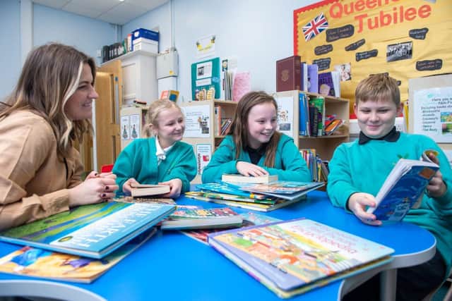 Class Teacher Victoria Rooney with Amelia (9), Baleigh (10) and Jake (10) reading together