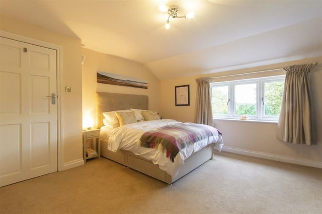 There are fitted wardrobes along one wall of the master bedroom which overlooks the rear of the house.