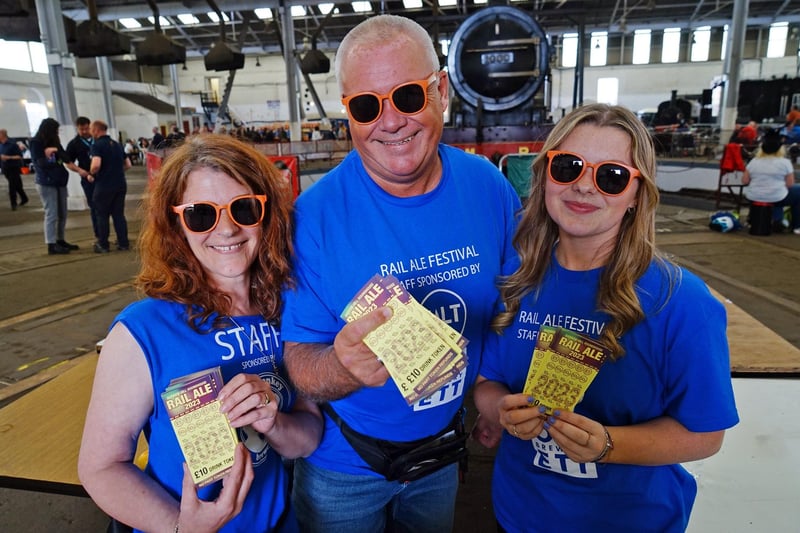 Donna Booth, Mark Robinson and Amelia Elvidge with beer tokens.