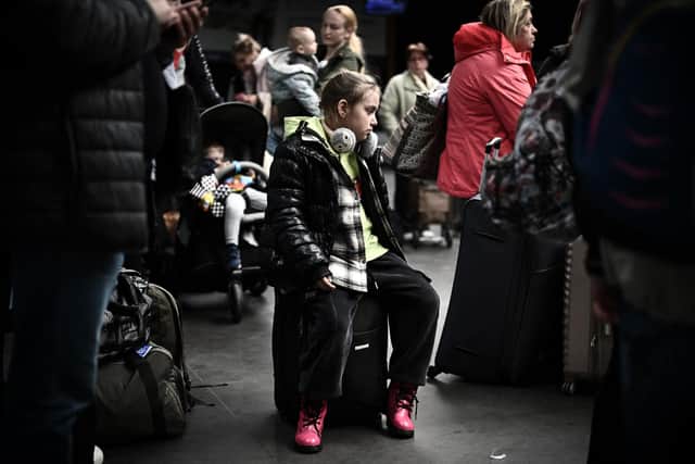 The first Ukrainian family has been welcomed to Derbyshire. Photo shows a young Ukrainian refugee sitting on a suicatse after disembarking from Moldova at the international airport of Bordeaux in Merignac. (Photo by Philippe LOPEZ / AFP) (Photo by PHILIPPE LOPEZ/AFP via Getty Images)