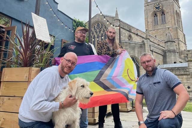 Ian Robson, chief executive of Derbyshire LGBT+, with the Progress Flag and Albert’s Cocktail mixologist Jordan Brown. In front Bar owner Ben Parr, with Poppy the Dog, and Business Partner Robin Howdle.