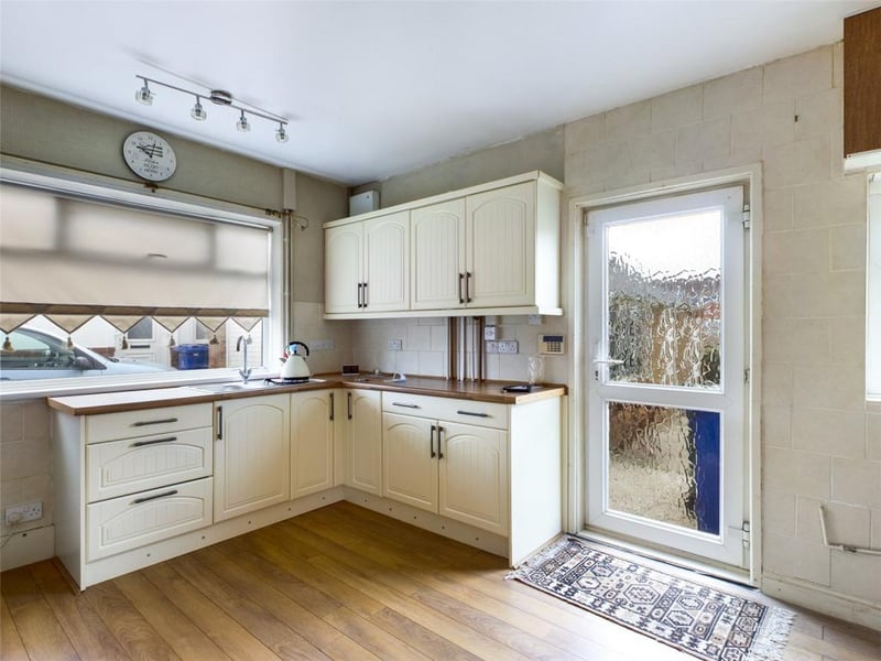 Kitchen with a range of wall and base units and worksurfaces
