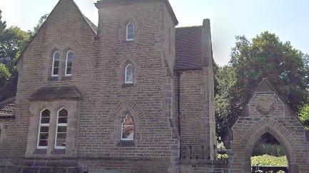 The  stone-built cemetery lodge has Gothic arched windows and a square tower containing three-storey accommodation. A gabled stone arch and gate pillars at the cemetery's entrance are also listed on Heritage England's register.