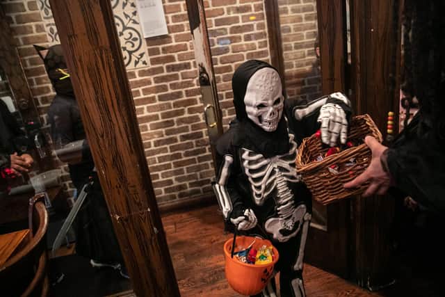 Children go trick-or-treat at a restaurant on Halloween, October 31,  (Photo by Jeenah Moon/Getty Images)