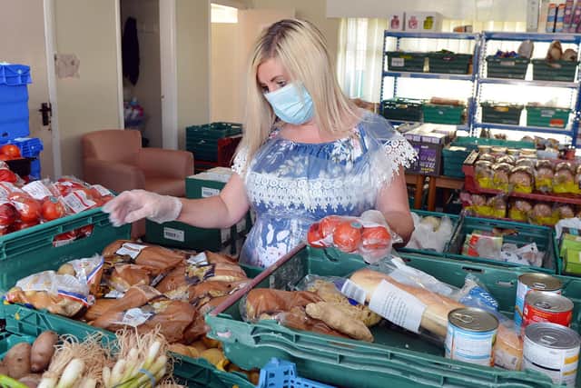 Chesterfield Community Food Hut volunteer Chelle Whitley sorting a food parcel.
