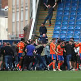 Three men have been handed football banning orders totalling nine years, after disorder at the Chesterfield v Oldham match last August.