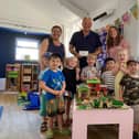 Matlock Pre-School staff Kirsty Tonks and Frances Crowfoot with Coun Steve Wain and Seb, Dylan, Lyla, Charlie, Jack, Harriet and Colton.