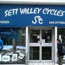 New Mills artist Clare Allan's artworks displayed in the window of Sett Valley Cycles.