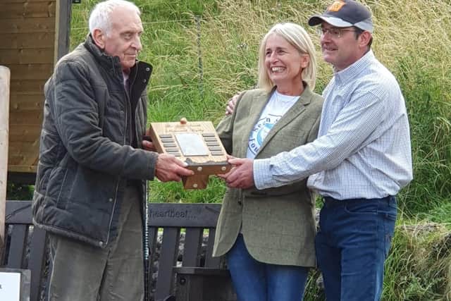 Susan Smith and Peter Lomas present the trophy to the clay pigeon shoot winner Nick Walker at Harboro Rocks Shoot where Sean was a member.