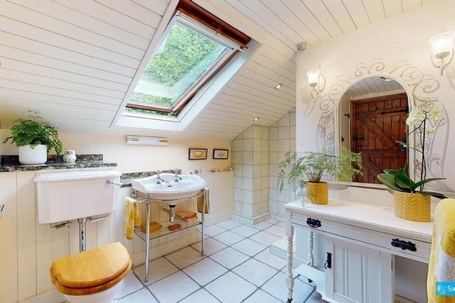 The rooflight window enables views over the wooded hillside. There is a Victorian-style wash basin, a shower cubicle with mixer shower and wc.