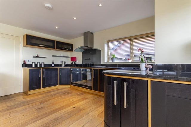 The contemporary kitchen contains integrated appliances Integrated appliances including a dishwasher, fridge, freezer, twin ovens and four-ring induction hob with extractor hod over.