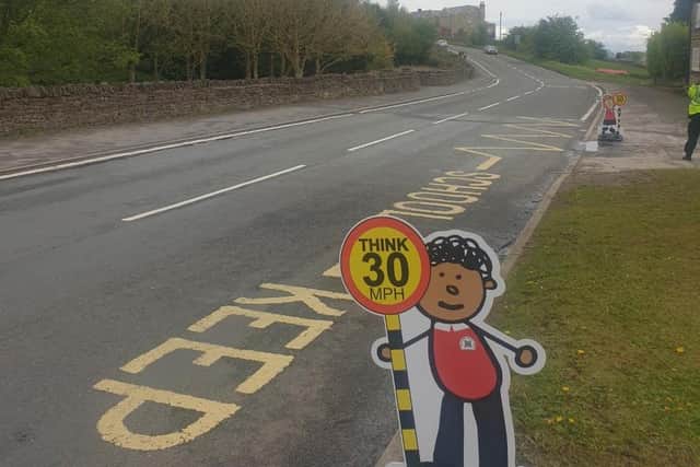Signs urging motorists to obey the speed limit outside Penny Acres Primary School in Holmesfield