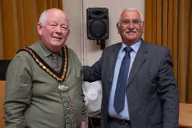 Councillor Burton, left, receiving the chain of office from Graham Elliott