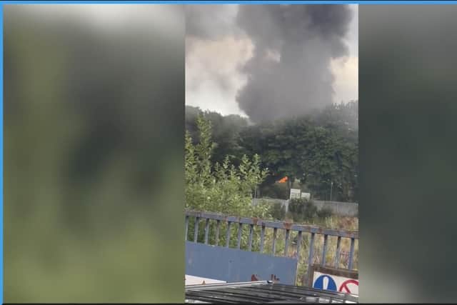 The video shows black smoke and flames on the site.