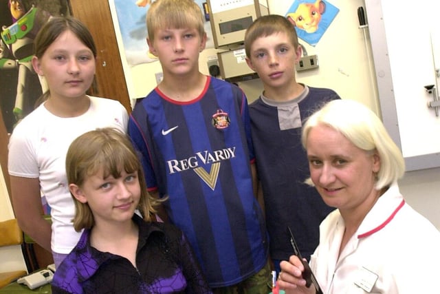 Youngsters from Chernobyl have their eyes tested at Chesterfield Royal Hospital, Opthalmic unit.Pictured are Oskana Ladutska, Sasha Sidorenko, Artyom Mikhailovsky and Maxim Petrochenko (all 12), with Senior Orthopist Janice Broome on July 18, 2003
