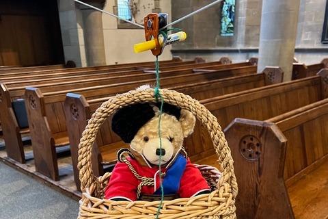 A regal teddy bear flew through the church at the opening of the exhibition.