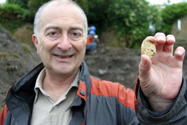 Tony Robinson holds up a gold coin as TV archeologists Time Team visit Codnor Castle