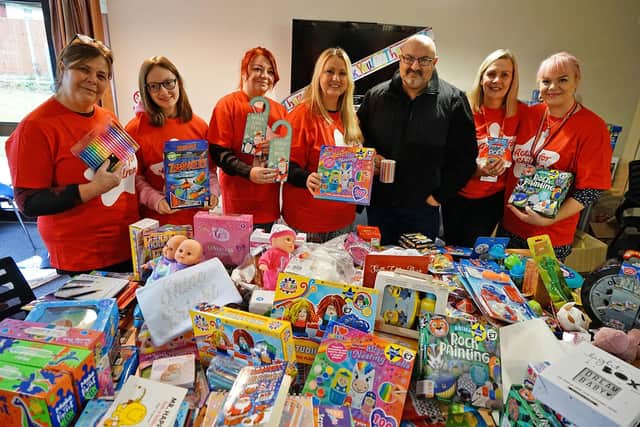 Sam Bannister has helped collect toys,toiletries and games for Action for Children on Queen St Chesterfield. Sam is seen with some of the toys and staff and volunteers.
