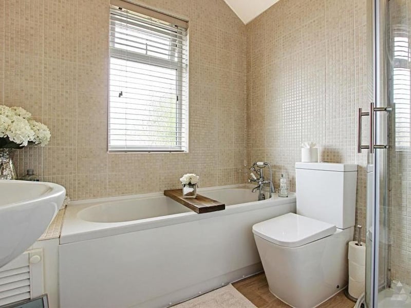 The family bathroom is a super highlight of the property. It features bath, separate walk-in shower, WC and wash hand basin.