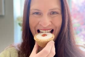 Jen Bell tucks into an Iced Cherry Bakewell Tart at The Bakewell Pudding Shop which has declared June 26 will be National Bakewell Tart Day.