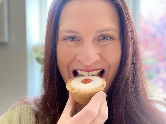 Jen Bell tucks into an Iced Cherry Bakewell Tart at The Bakewell Pudding Shop which has declared June 26 will be National Bakewell Tart Day.