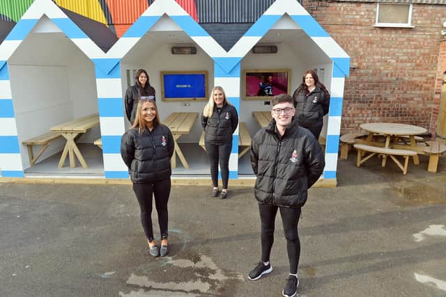 Staff at the Spotted Frog, on Chatsworth Road, Chesterfield, prepare to reopen with new 'beach huts' for customers.