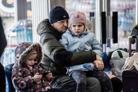 A Ukrainian refugee hugs his grandchild at a Ukrainian refugee centre during the early days of the conflict. (Photo by Hristo Rusev/Getty Images)