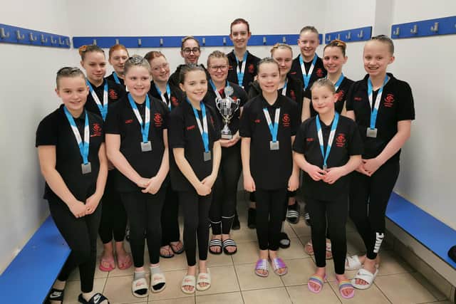 The club's artistic swimmers with their trophy.