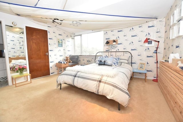 How cute is this guest suite bedroom with the yacht sail stretched across the ceiling to match the design of the wallpaper?
