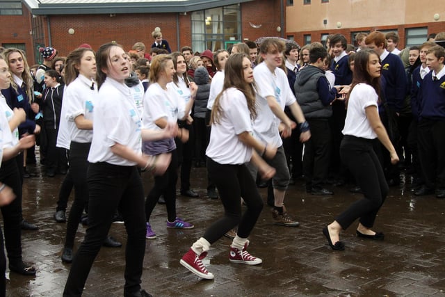Just Dance: Pupils at Tupton Hall school take part in a rather rainy Flash Mob at lunchtime as part of their anti bullying campaign in 2012