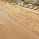 This aerial picture shows the campaigners' message in the sand at Bridlington.