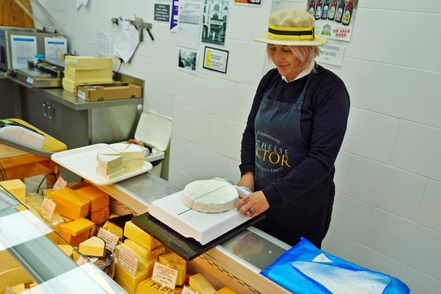 Nikki Perrins slicing French Brie.