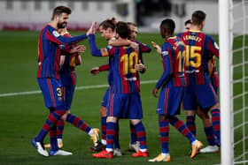 Lionel Messi celebrates with teammates after scoring for Barcelona against Real Betis. (Photo by Eric Alonso/Getty Images)
