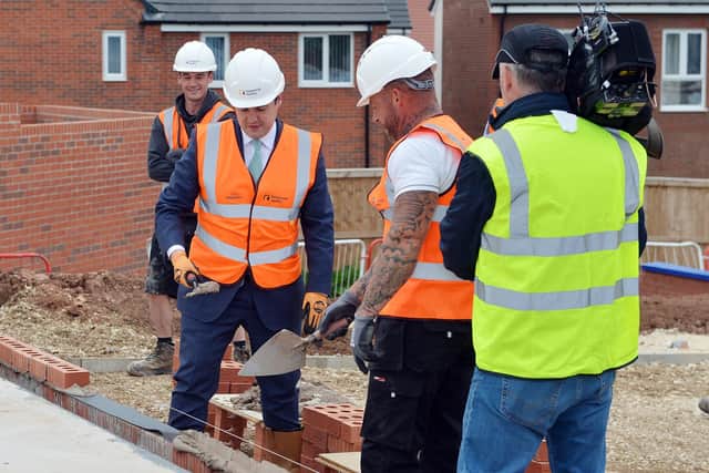 The Secretary of State for Housing RT Hon Robert Jenrick MP visited Shirebrook in the Bolsover district on Friday, June 4,  to mark the launch of the Governments First Homes scheme. Pictured is Mr Jenrick laying a brick with help from Lee Cousins.